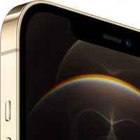 Close-up of a gold smartphone with a rainbow reflection on the screen, gold
